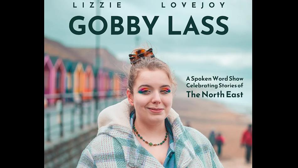 Lizzie Lovejoy, 'Gobby Lass' wearing colourful eyeshadow, standing at the beach, next to vibrant beach houses