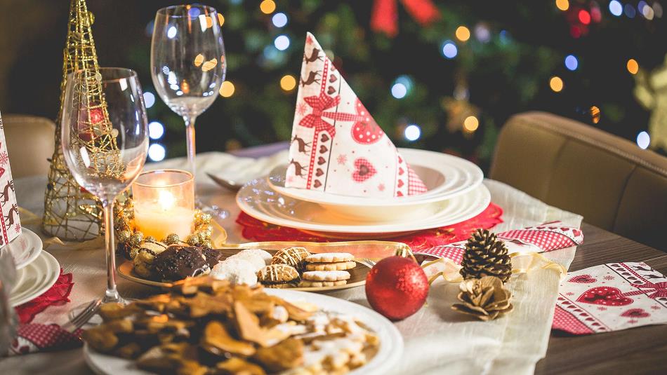 Table at Bowburn Hall set for Christmas Day Lunch with Christmas decor, treats, wine and candles.