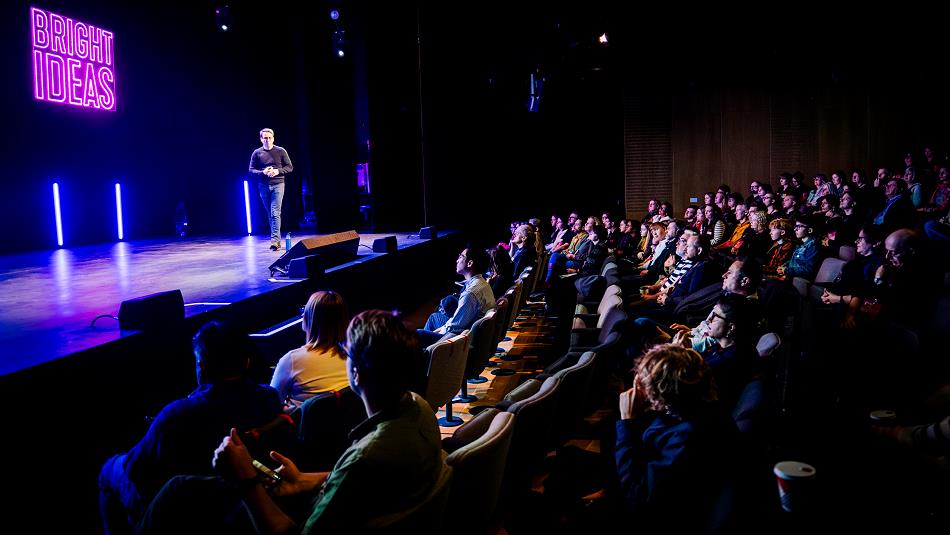 Speaker addressing the crowd at the Bright Ideas Gathering.