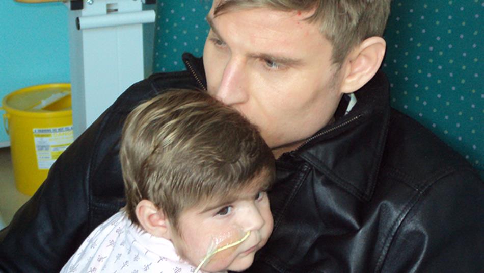 Scott Bennett kissing his daughter on the head