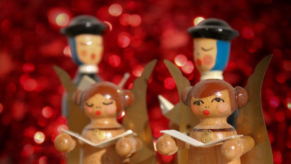 Wooden figure display showing four carol singers