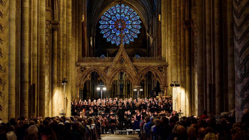 Durham University Orchestral Society performing beneath the Rose Window in the Nave of Durham Cathedral