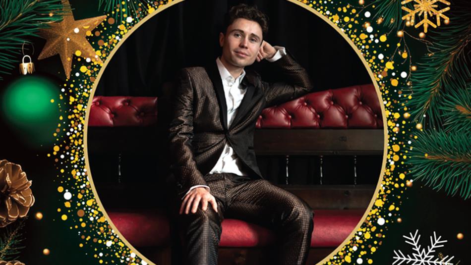 Singer, Alex Hall, reclining on a chair. Poster contains a border of Christmas baubles, stars, pine cones and glitter.