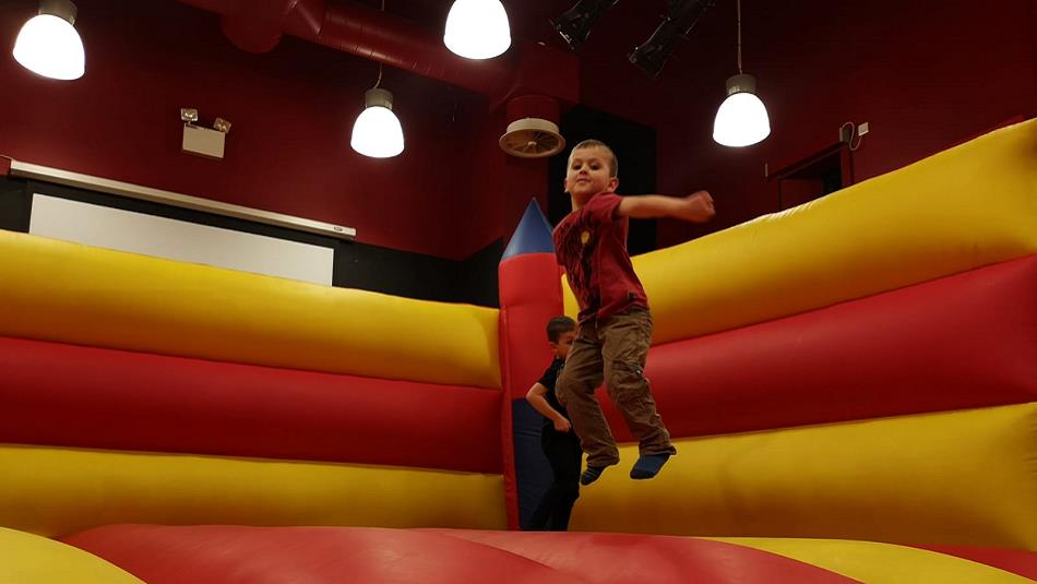 A child enjoying playing on a bouncy castle