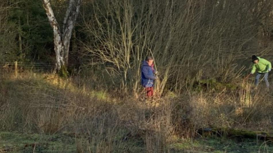 Two people taking care of the Heathland around Derwent Reservoir