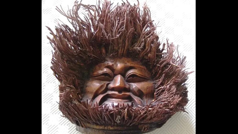 A face carved from wood
