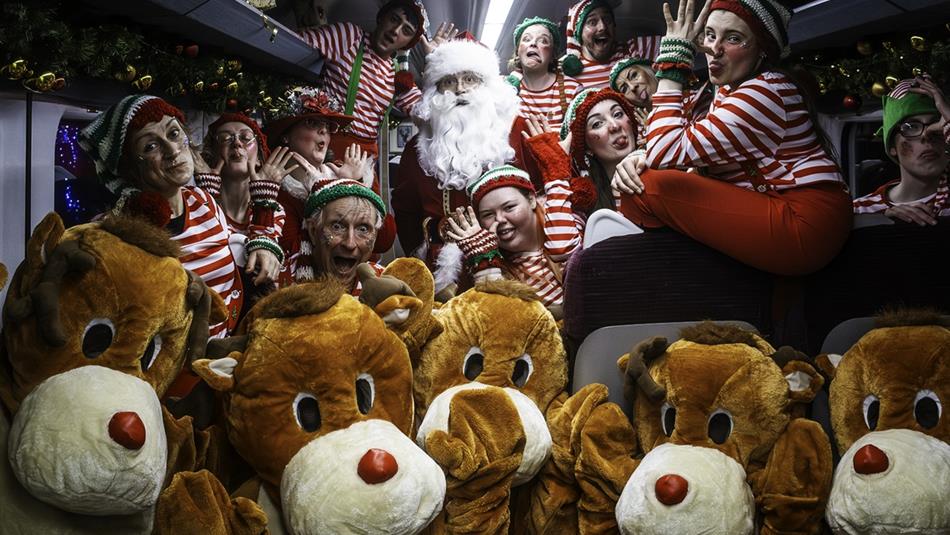 Santa and his helpers aboard the train.