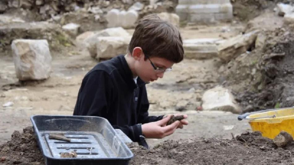 A child digging for archaeological artefacts