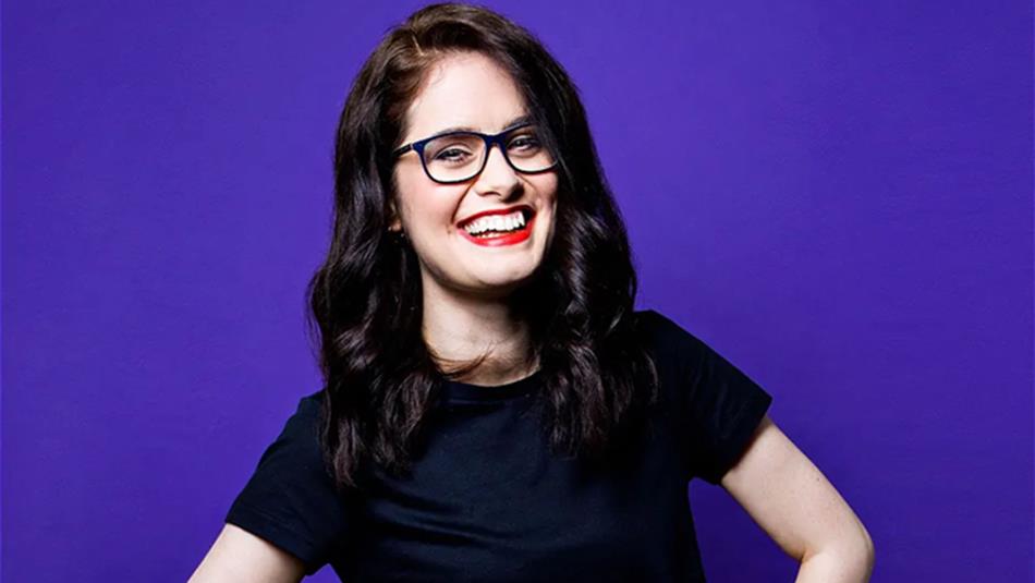 Adele Cliff, with hands on hips, smiling.