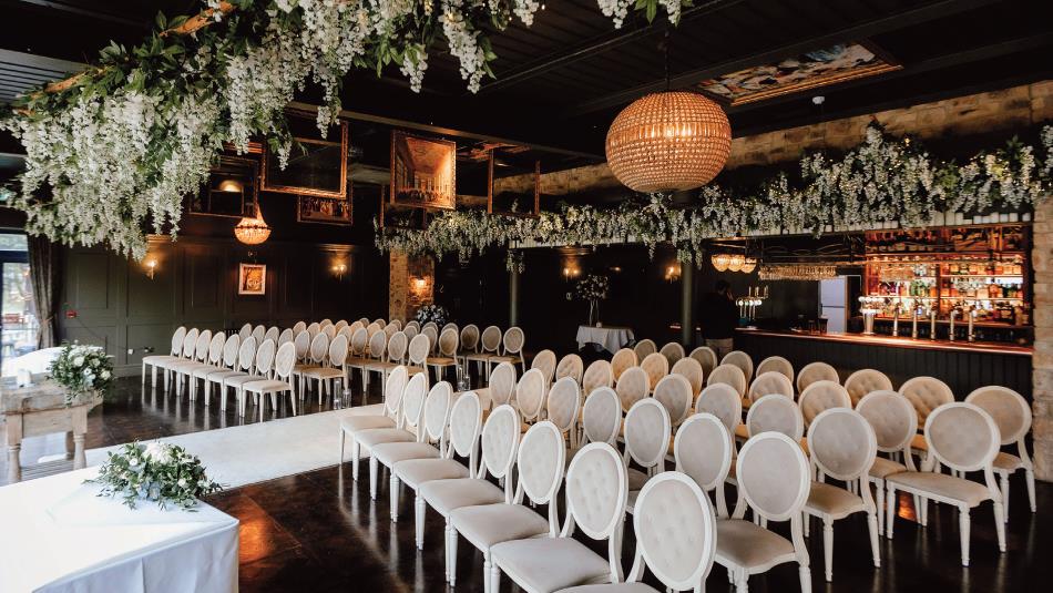 Bowburn Hall staged beautifully for a wedding with rows of chairs and floral decorations.