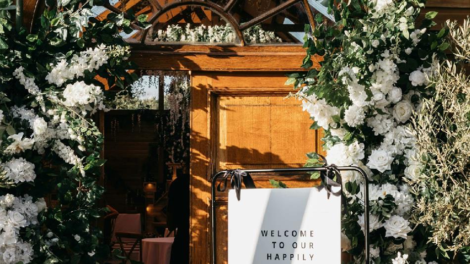 Floral wedding decorations around a door at Ramside Hall Hotel.