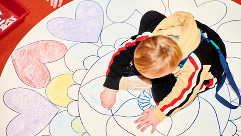 Child colouring in mandala pattern.