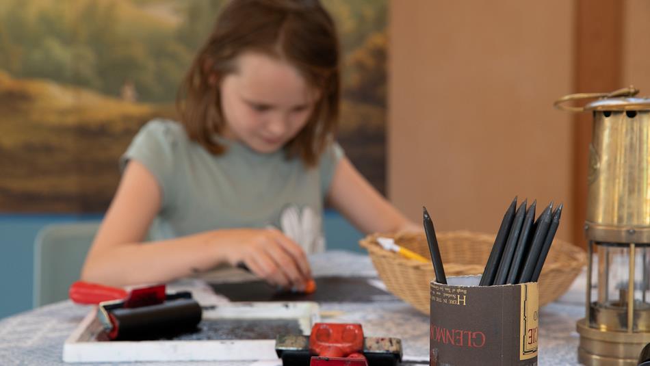 A girl enjoying a drop-in printmaking session at No.42