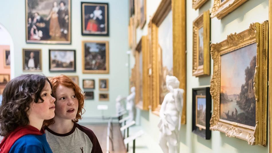 Two children look at artwork at The Bowes Museum