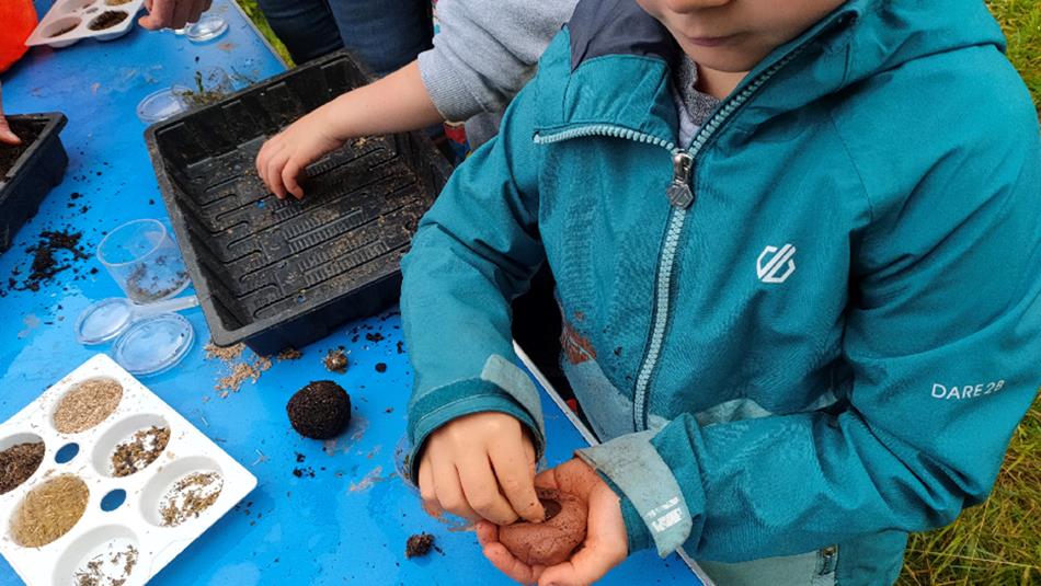 child with seeds in their hand