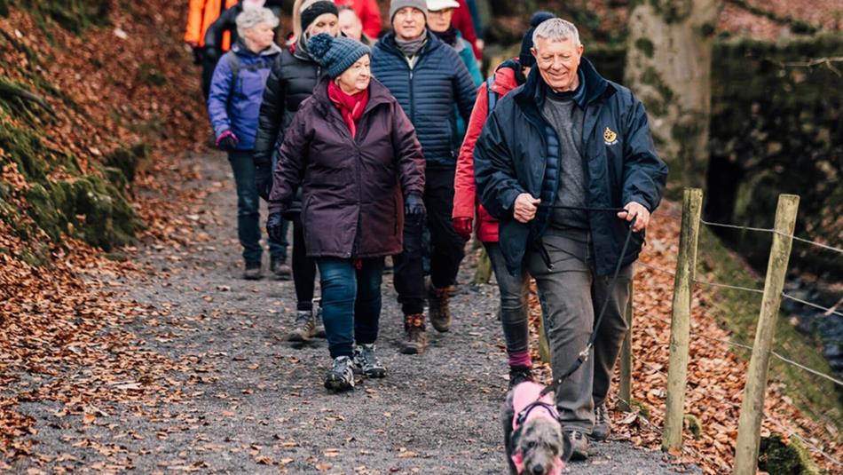 A group enjoying a walk with a dog at High Force - Social Sundays.