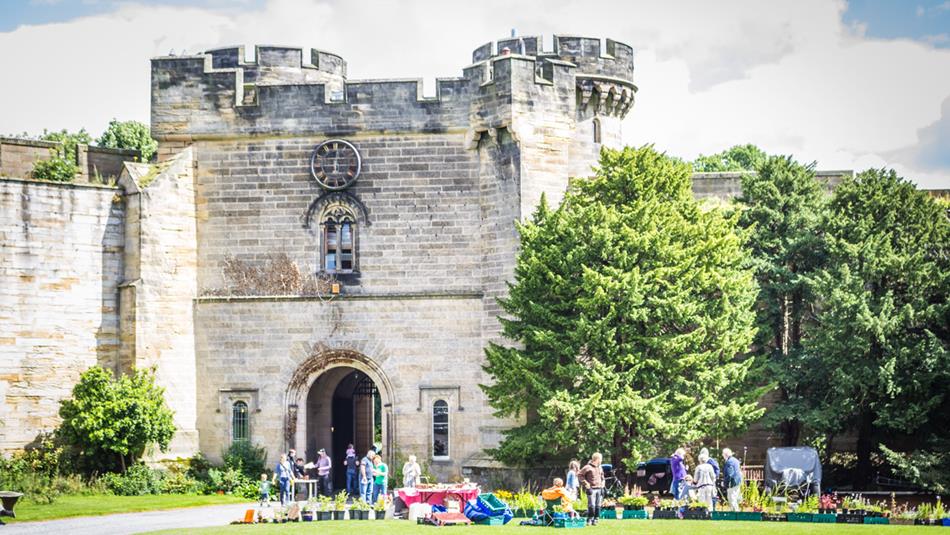 People outside Brancepeth Castle on a sunny day enjoying the Summer Craft Fair.