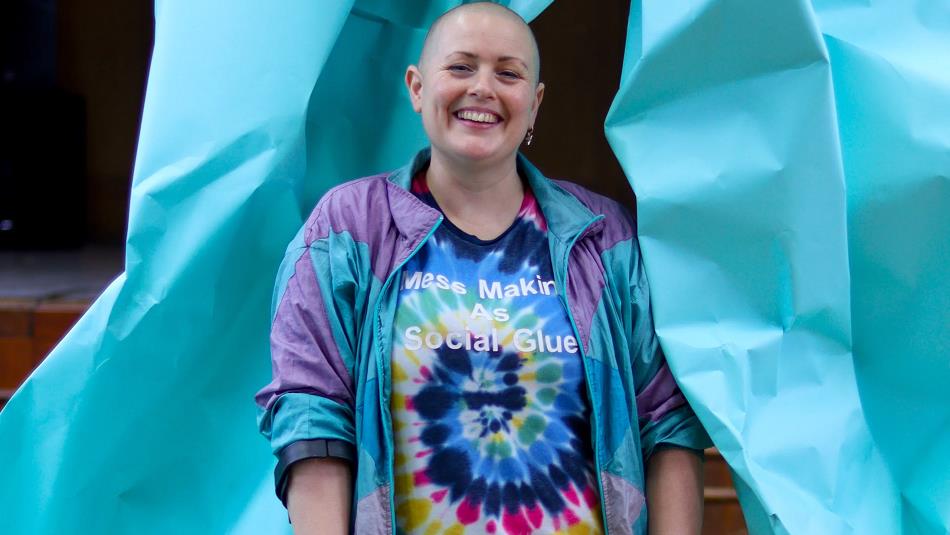 Lady Kitt, in a vibrant t shirt, smiling