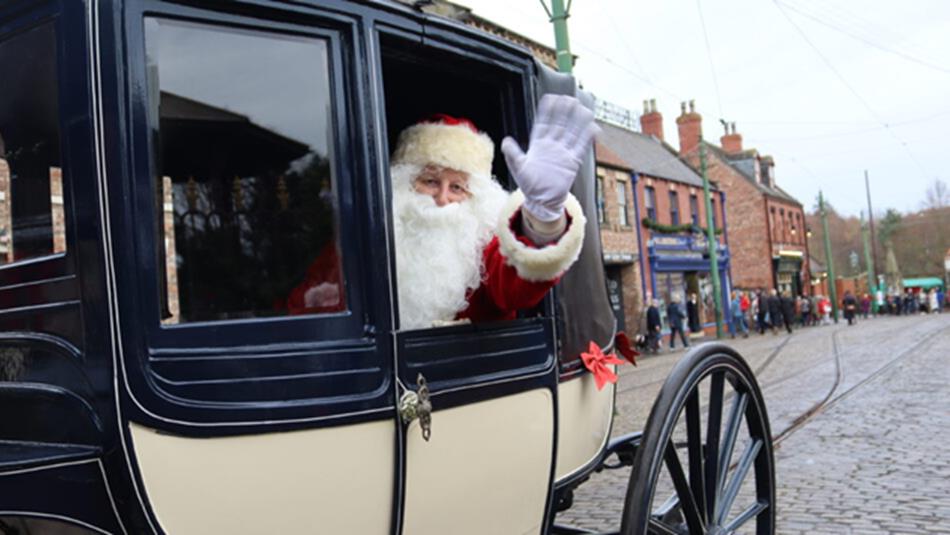 Father Christmas waving from a carriage at Beamish Museum.