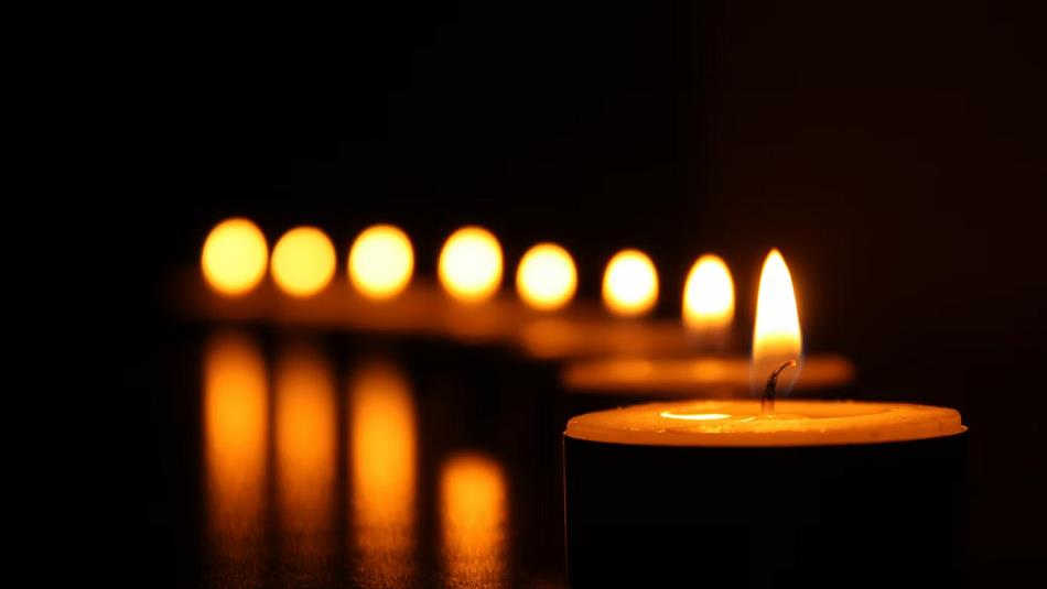 A row of candles lighting the dark.