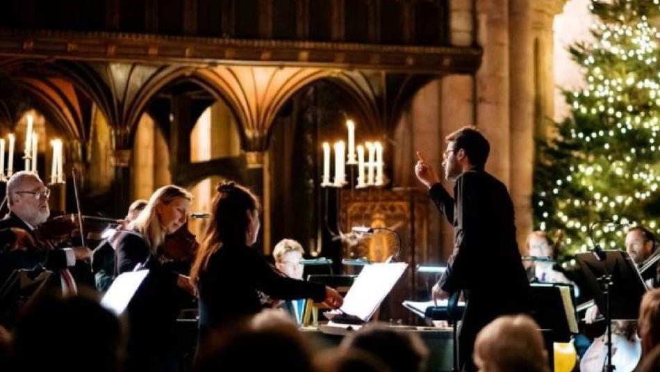 Royal Northern Sinfonia performing in front of a Christmas Tree.