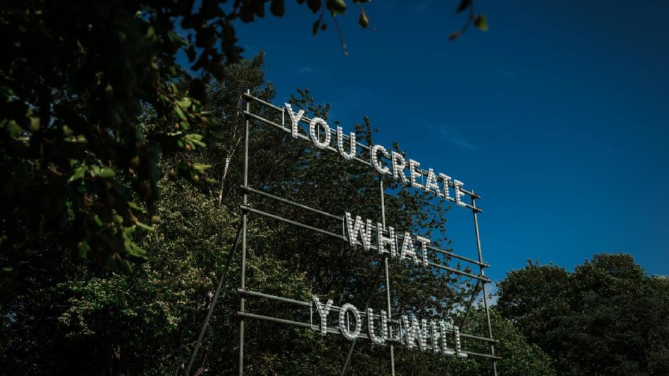 ©TheBowesMuseum
A structure in front of the trees with the words, 'You Create What You Will'.