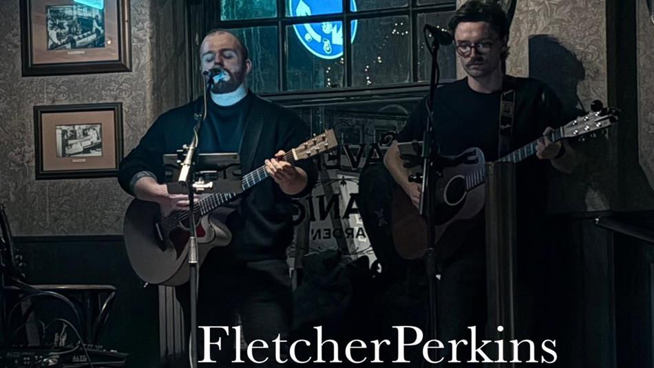 Fletcher Perkins performing on stage with their guitars.