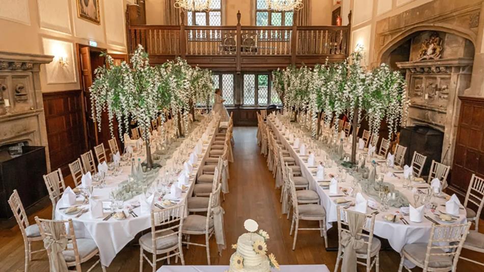 2 tables, banquet style, beautifully decorated for a wedding.