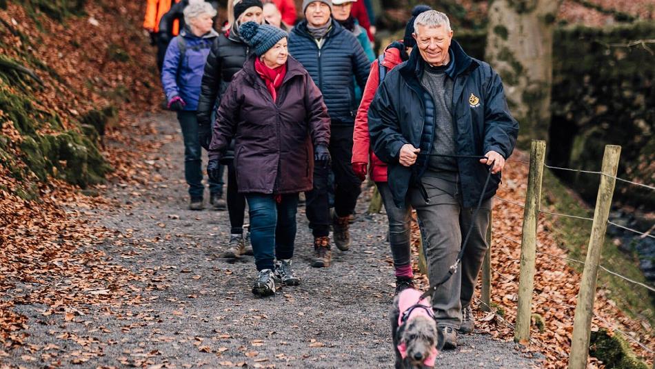 A group walking at High Force with their dog.