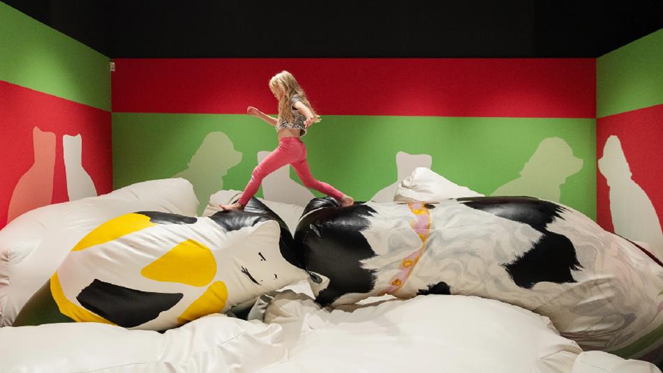 Girl running over larger-than-life, soft recreations of animal figurines - Pippa Hale Pet Project