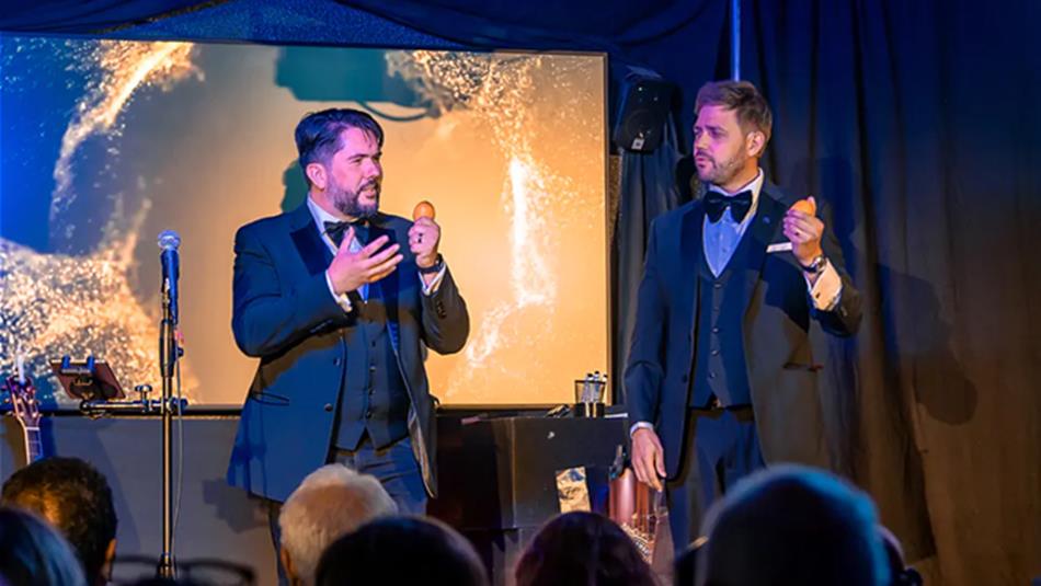 Tim Lichfield and Andy Larmouth, Magic Duo on stage holding eggs.