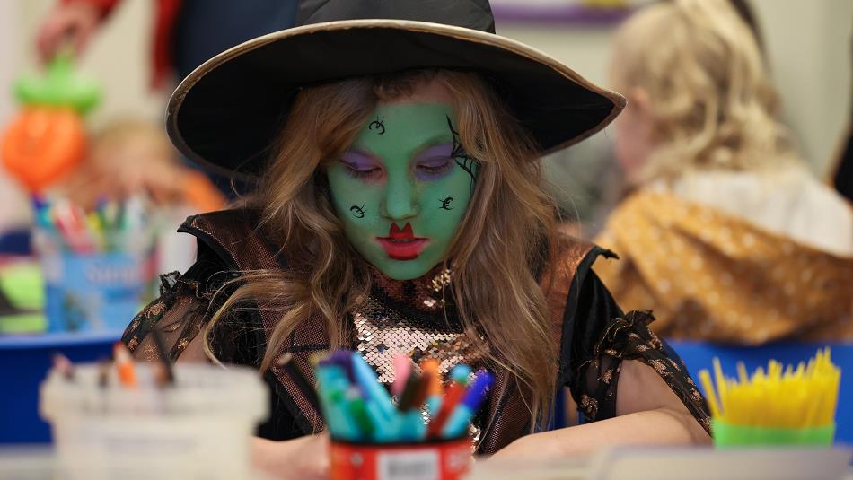 A little girl  wearing a handcrafted witch's hat. Hopetown Darlington.