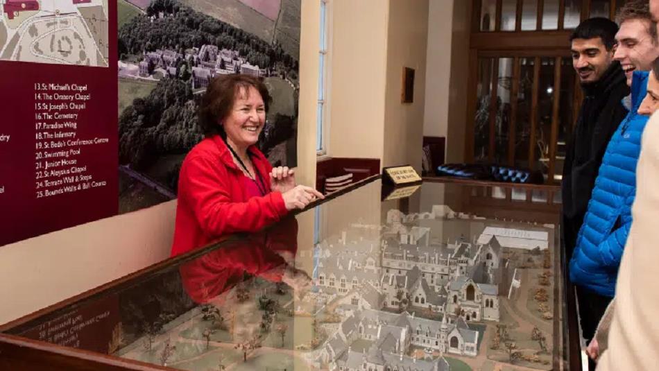 Visitors being shown a model of Ushaw by staff.