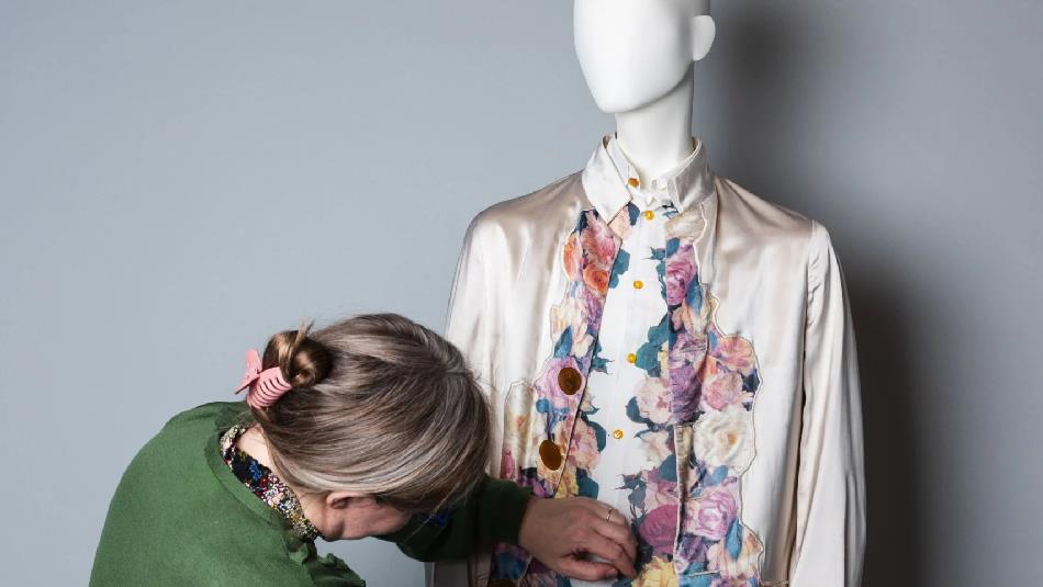 Rachel Whitworth, Curator of Fashion & Textiles, adjusting clothing on a mannequin ©ClaireCollinsonPhotography