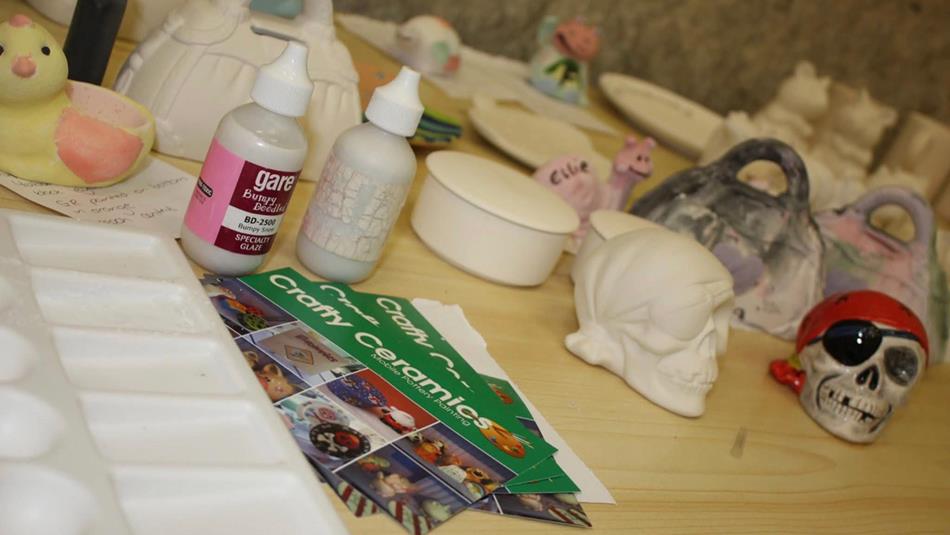 Craft materials and painted items such as skulls and ducks.