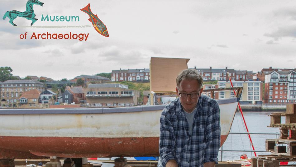 Artist Stephen Livingstone works on a sculpture and there are boats, houses and a river in the background.