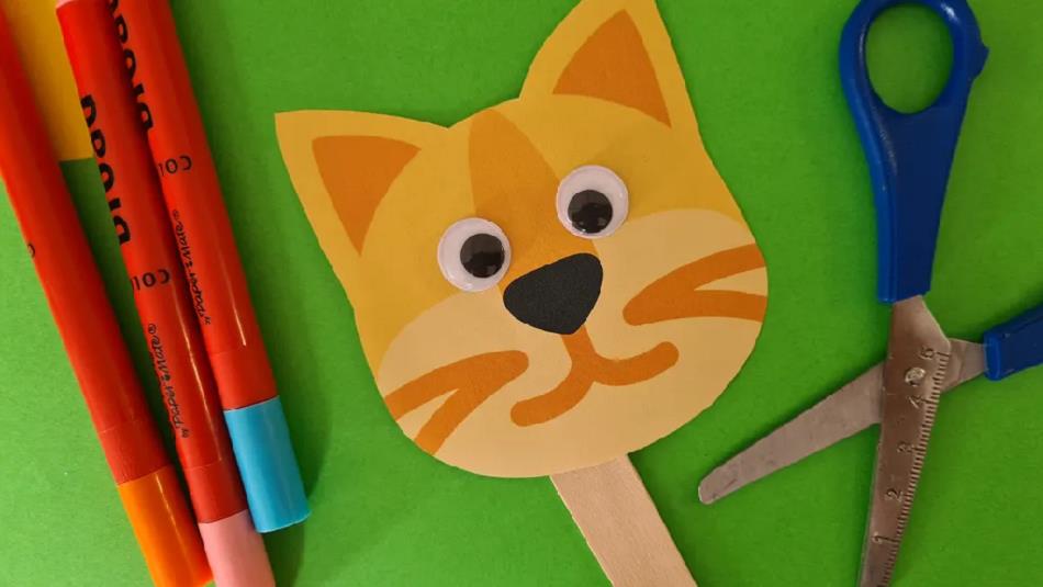 Pens, scissors and a handcrafted cat puppet