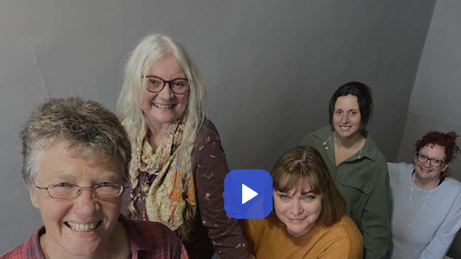 5 people on a stairwell, smiling.