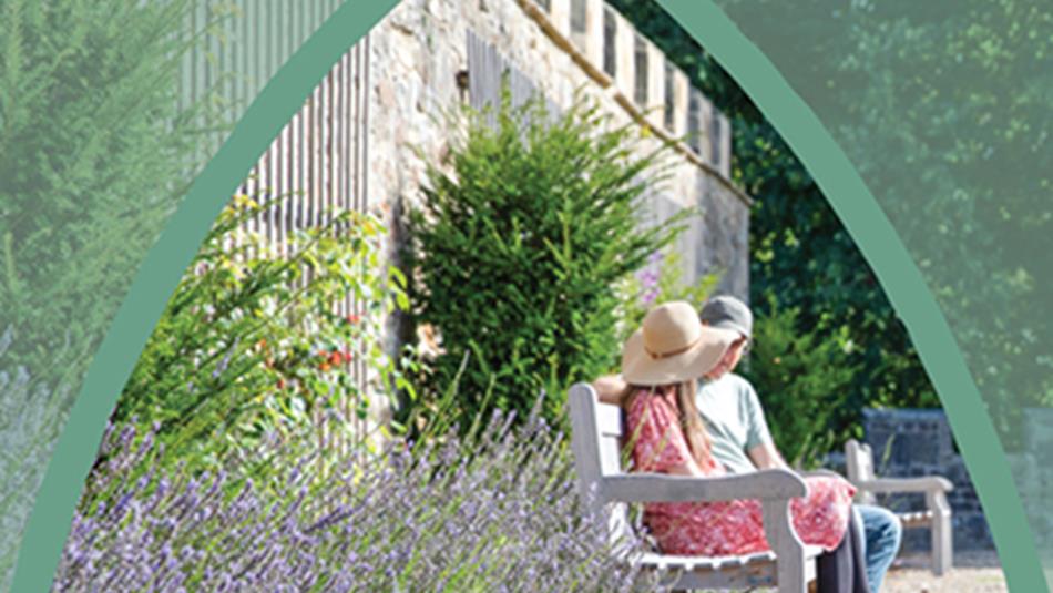 A couple sitting on a bench at Auckland Gardens enjoying a sunny day