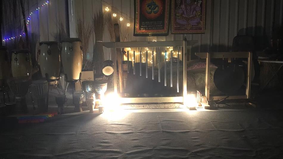 Drums in a steel barn decorated with fairy lights and cushions