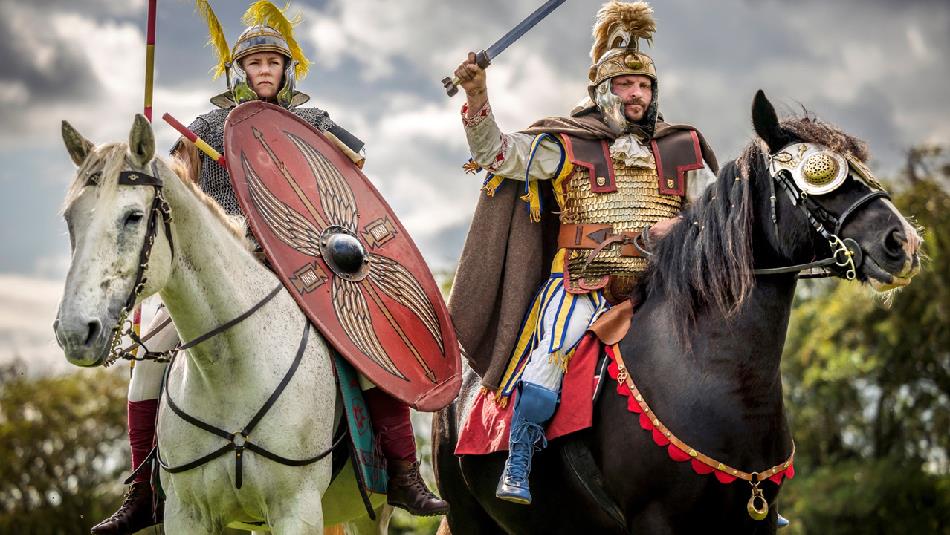Two Roman soldiers riding horses into battle