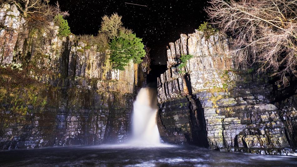 Family Stargazing. Starry night's sky over High Force Waterfall.
