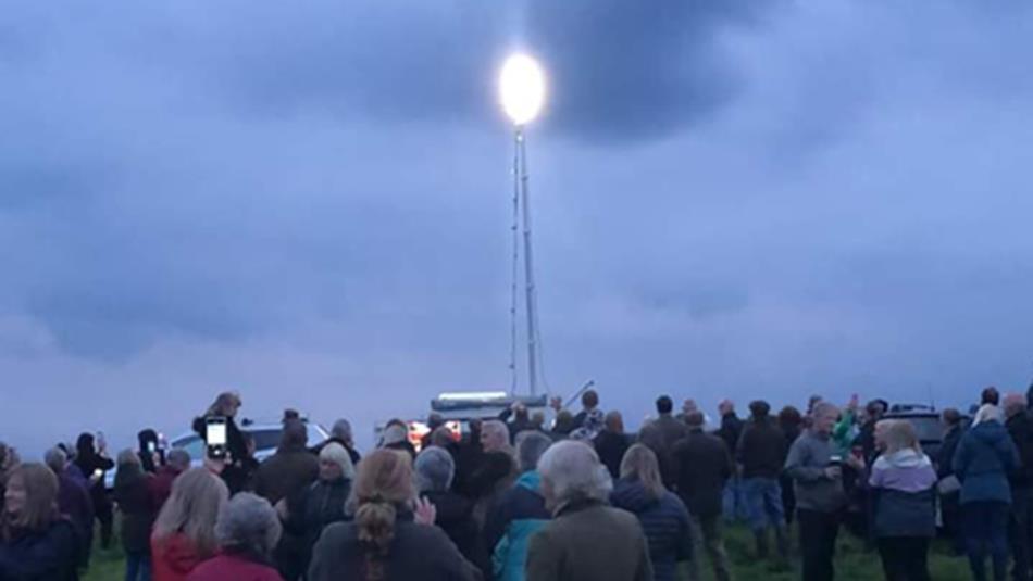 Crowds commemorating VE Day with a beacon.