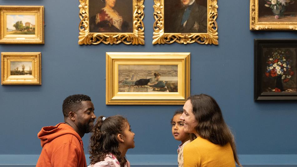 A family looking at artwork at The Bowes Museum 
