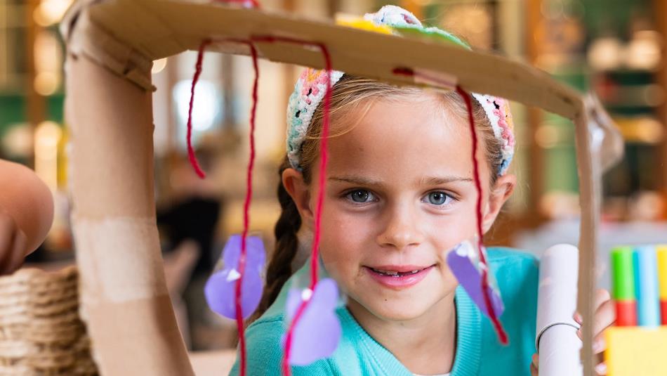 Little girl making a sculpture from wool.