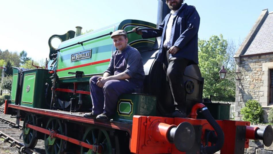 Two staff perched on Victorian steam locomotive ‘Sir Berkeley’.