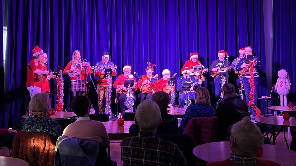 D'Ukes of Scarth performing at Christmas in Santa hats.