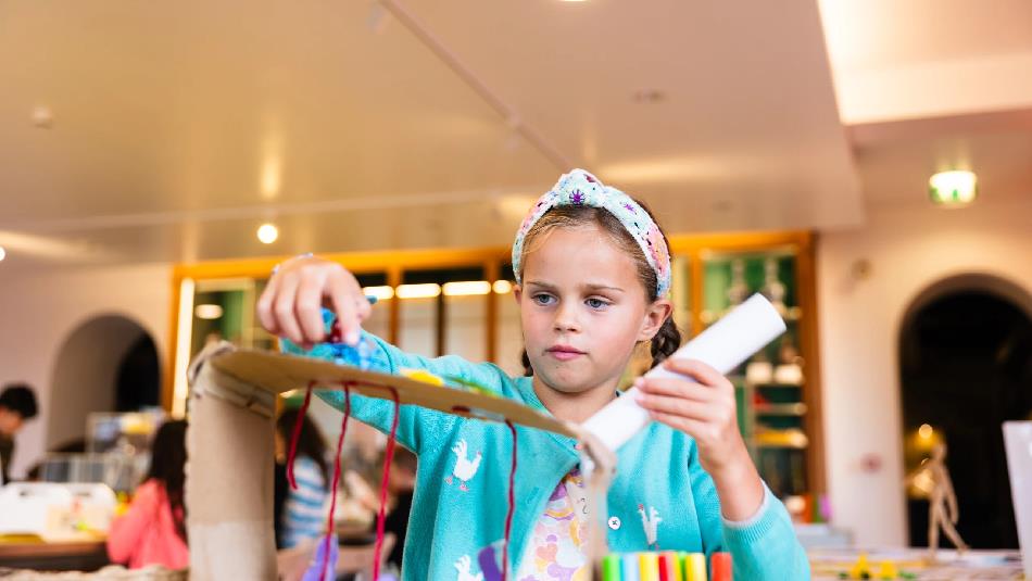 A child partaking in arts and crafts at The Bowes Museum