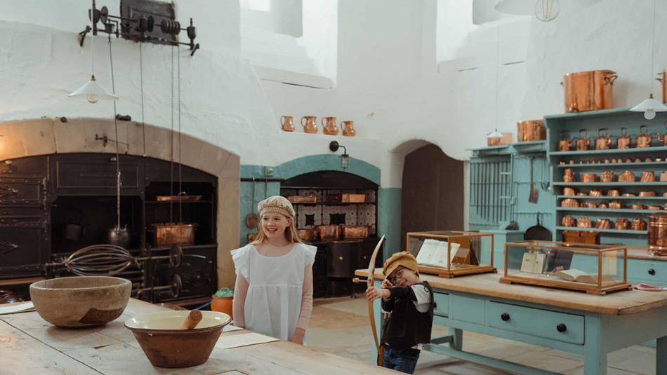 Children dressed as castle servants in the kitchen at Raby.