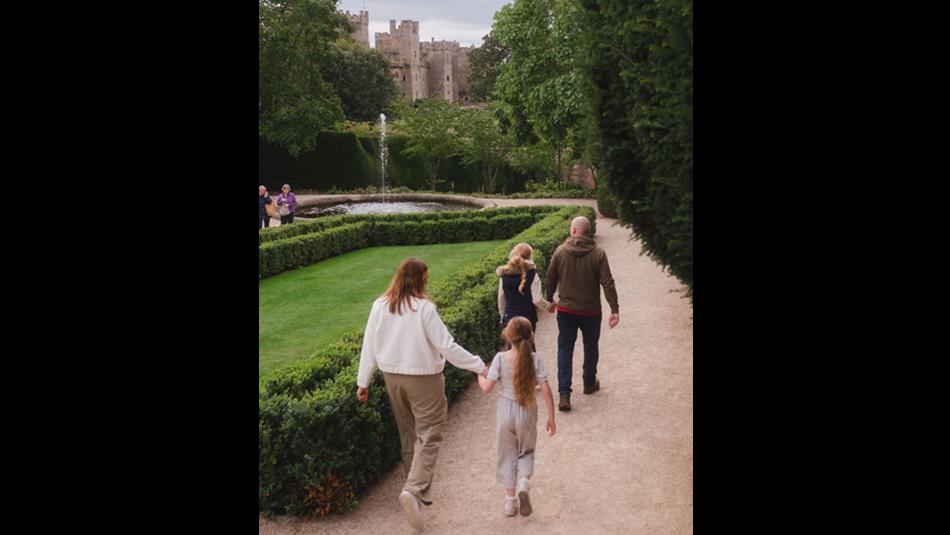 Family walking in the grounds of Raby Castle, Park and Gardens.
